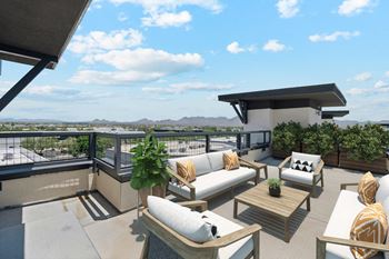 a furnished balcony with couches and a table